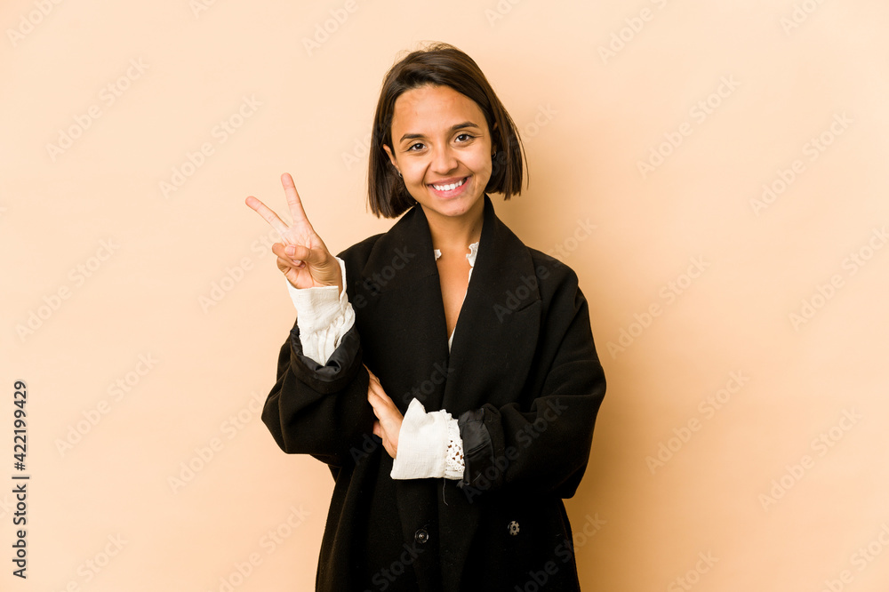Young hispanic woman isolated showing number two with fingers. Young hispanic woman isolated showing number two with fingers.