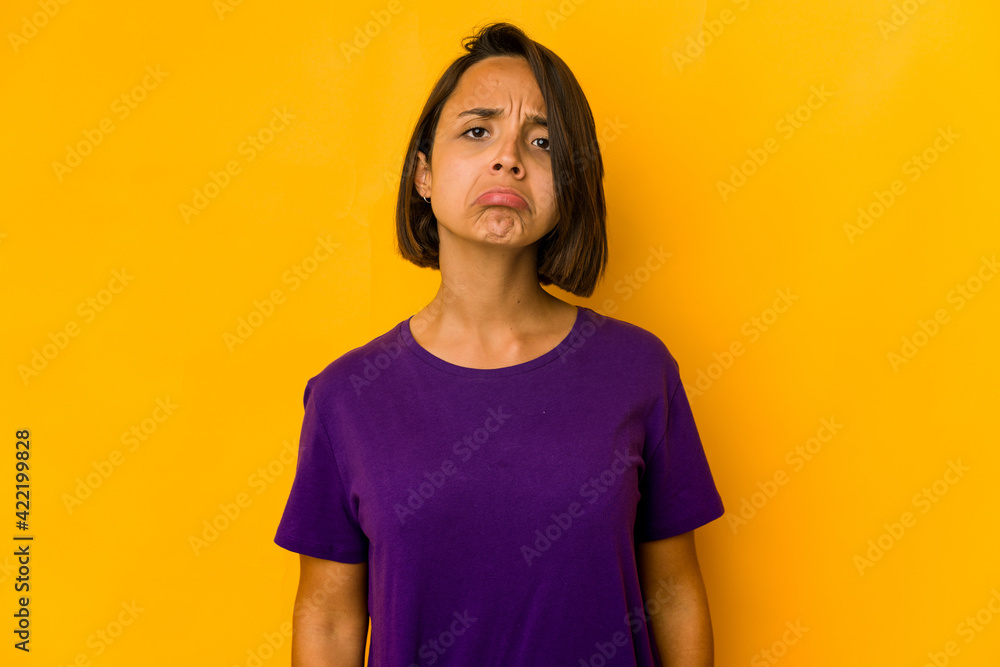 Young hispanic woman isolated on yellow sad, serious face, feeling miserable and displeased. Young hispanic woman isolated on yellow sad, serious face, feeling miserable and displeased.