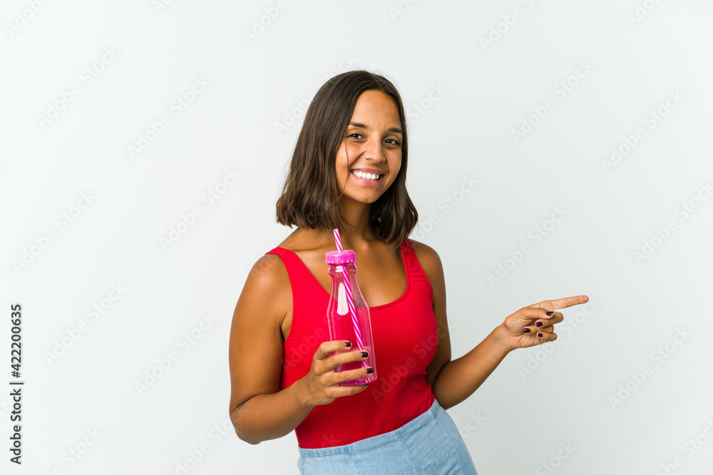 Young latin woman holding a milkshake isolated on white background Young latin woman holding a milkshake isolated on white background