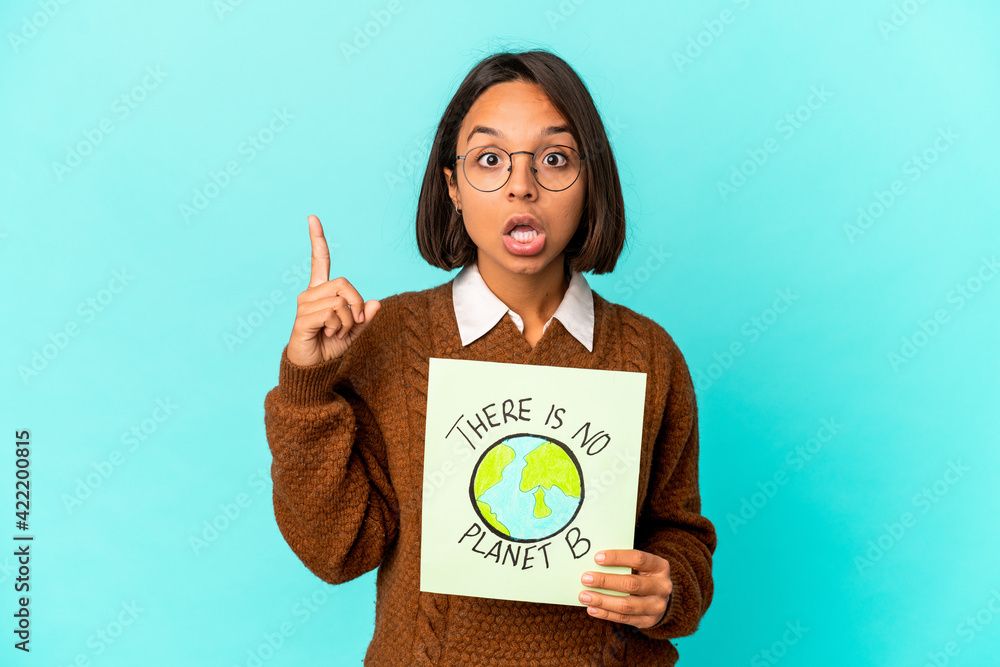 Young hispanic mixed race woman holding a planet save placard having an idea, inspiration concept. Young hispanic mixed race woman holding a planet save placard having an idea, inspiration concept.