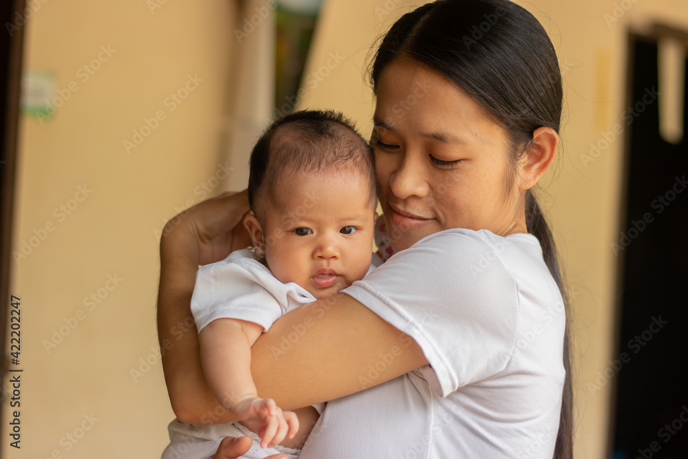 Young Asian mother holding little daughter in the park, Mother play enjoying with her cute baby girl in outdoor, copy space Young Asian mother holding little daughter in the park, Mother play enjoying with her cute baby girl in outdoor, copy space