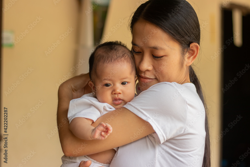 Young Asian mother holding little daughter in the park, Mother play enjoying with her cute baby girl in outdoor, copy space Young Asian mother holding little daughter in the park, Mother play enjoying with her cute baby girl in outdoor, copy space