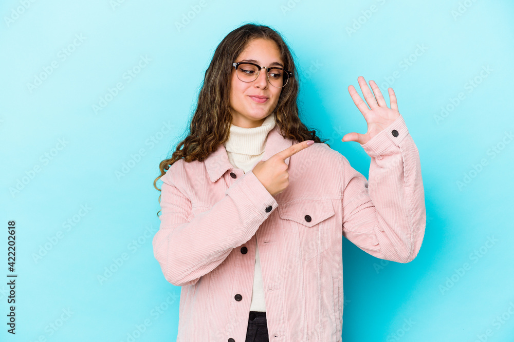 Young caucasian curly hair woman isolated smiling cheerful showing number five with fingers. Young caucasian curly hair woman isolated smiling cheerful showing number five with fingers.