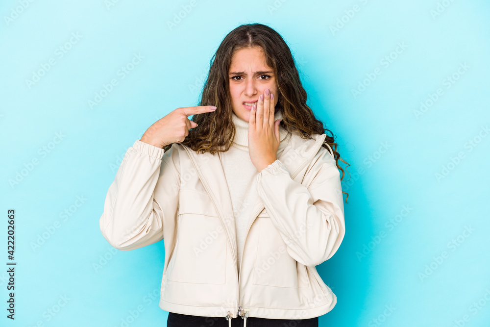 Young caucasian curly hair woman isolated having a strong teeth pain, molar ache. Young caucasian curly hair woman isolated having a strong teeth pain, molar ache.