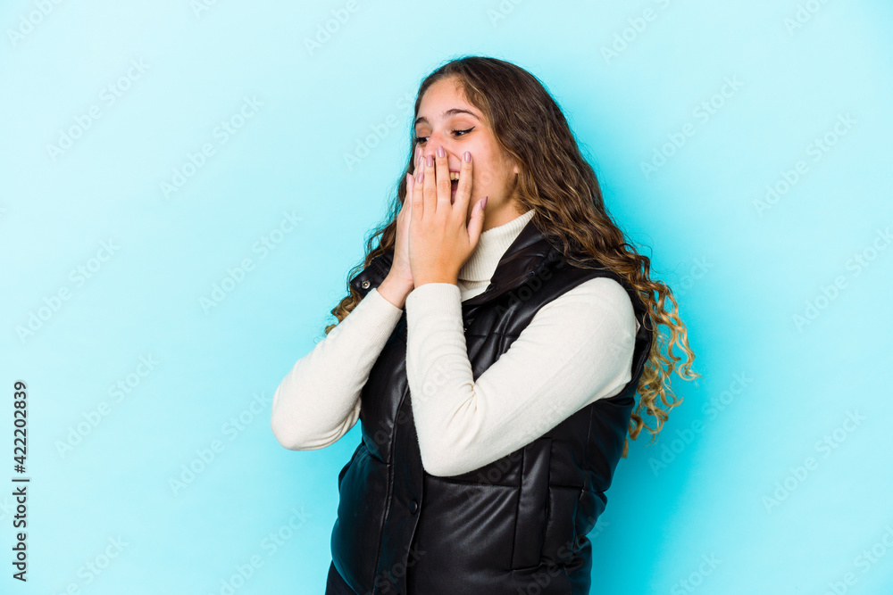 Young caucasian curly hair woman isolated laughing about something, covering mouth with hands. Young caucasian curly hair woman isolated laughing about something, covering mouth with hands.