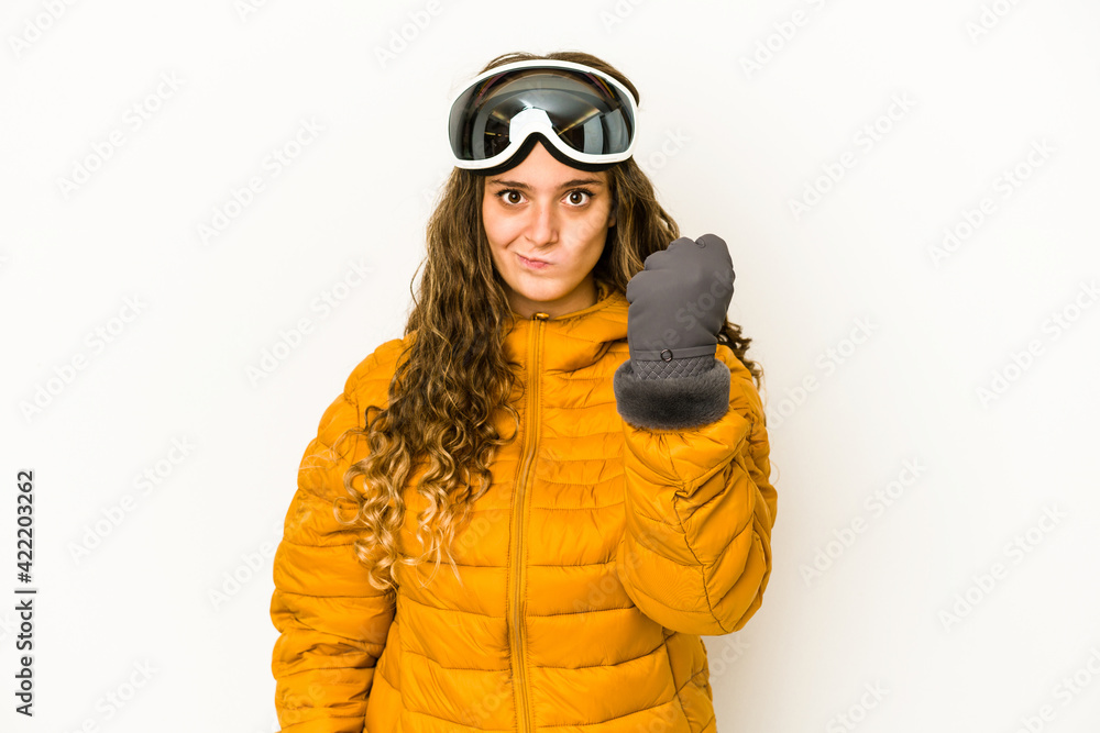 Young caucasian snowboarder woman isolated showing fist to camera, aggressive facial expression. Young caucasian snowboarder woman isolated showing fist to camera, aggressive facial expression.