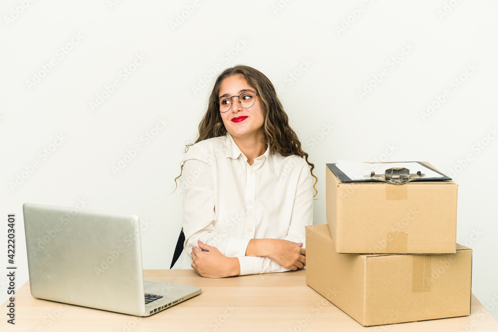 Young caucasian worker of a parcel company isolated dreaming of achieving goals and purposes Young caucasian worker of a parcel company isolated dreaming of achieving goals and purposes