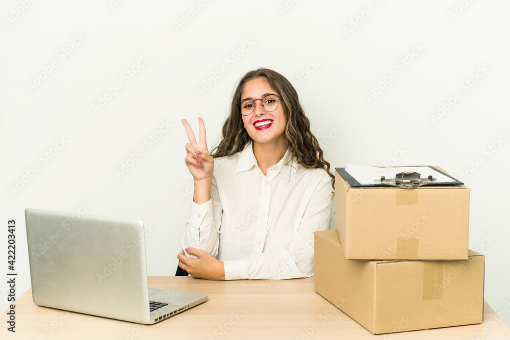 Young caucasian worker of a parcel company isolated showing number two with fingers. Young caucasian worker of a parcel company isolated showing number two with fingers.