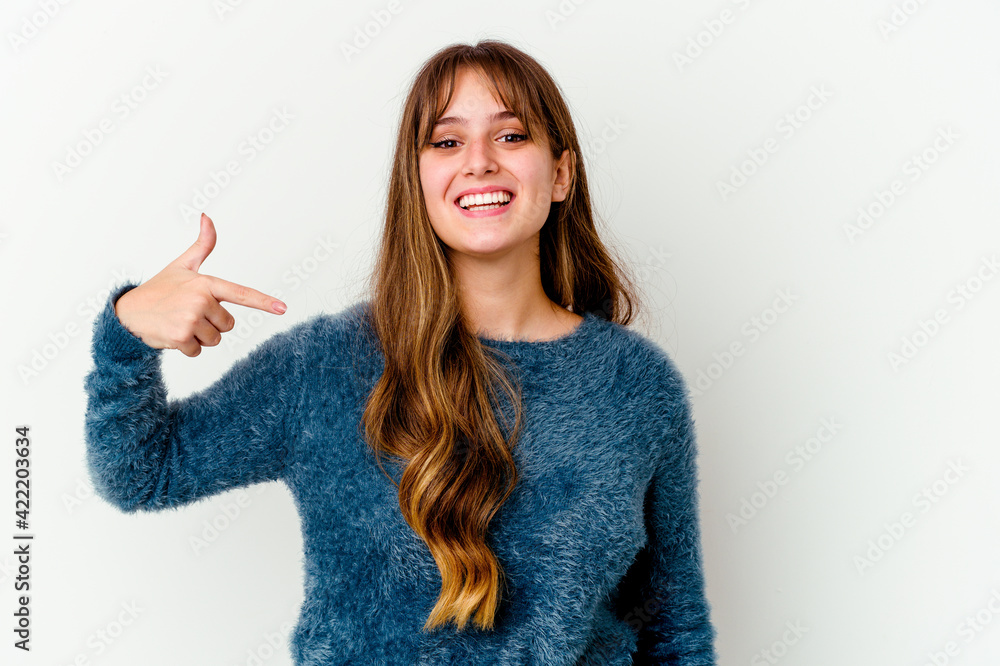Young caucasian cute woman isolated on white background person pointing by hand to a shirt copy space, proud and confident Young caucasian cute woman isolated on white background person pointing by hand to a shirt copy space, proud and confident