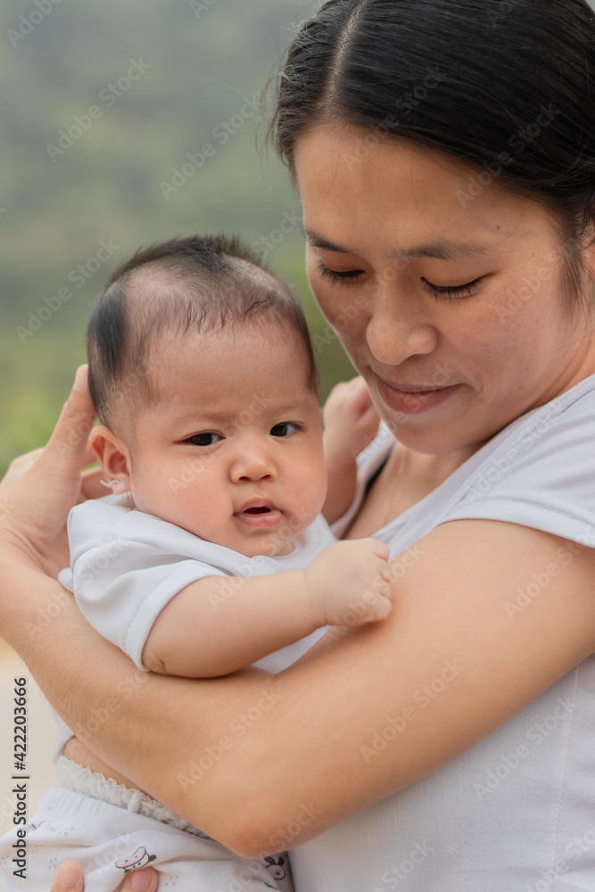 Young Asian mother holding little daughter in the park, Mother play enjoying with her cute baby girl outdoor, copy space
Young Asian mother holding little daughter in the park, Mother play enjoying with her cute baby girl outdoor, copy space