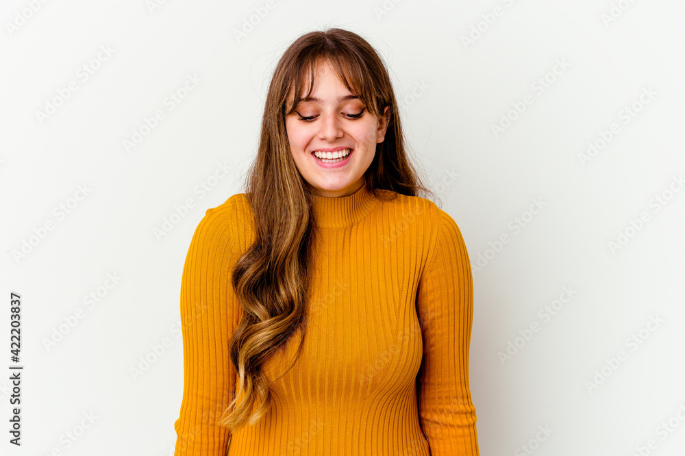 Young caucasian cute woman isolated on white background laughs and closes eyes, feels relaxed and happy. Young caucasian cute woman isolated on white background laughs and closes eyes, feels relaxed and happy.