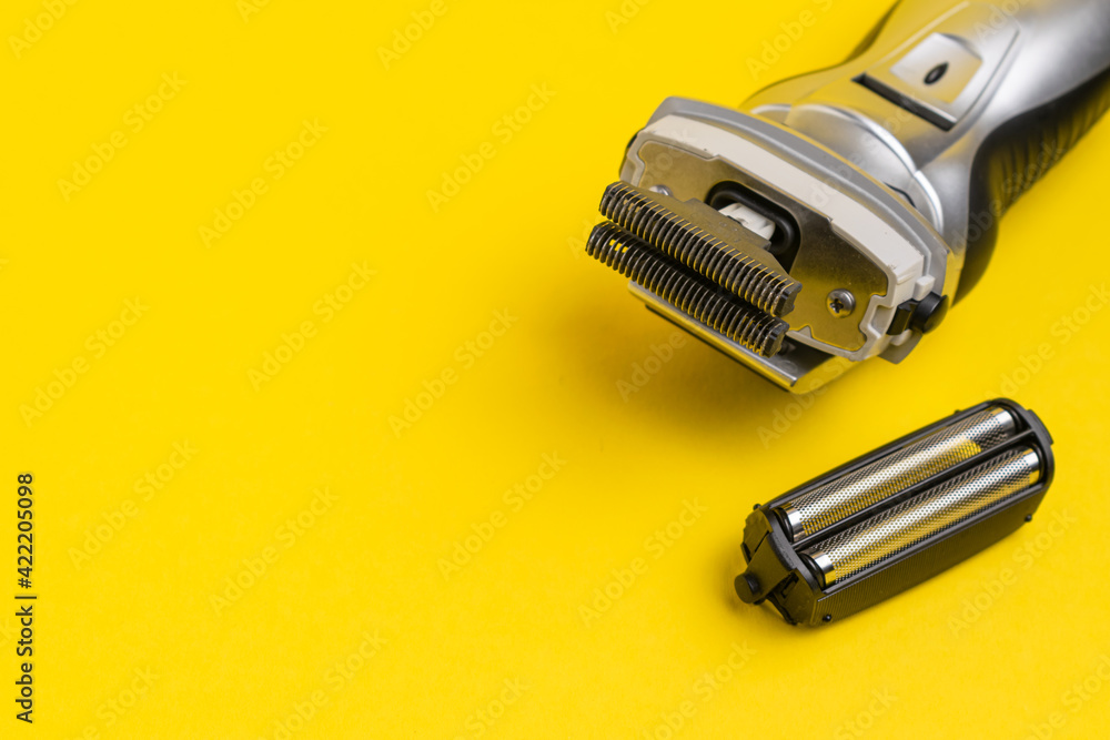 Electric shaver on a yellow background on the right, on the left there is a place for an inscription Electric shaver on a yellow background on the right, on the left there is a place for an inscription