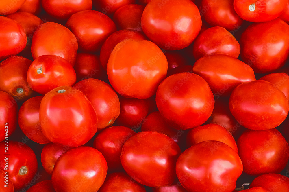 Heap of red Ukrainian tomatoes background on the market Heap of red Ukrainian tomatoes background on the market