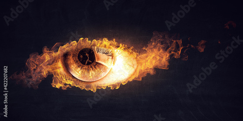Macro image of human eye with fire flames © Sergey Nivens