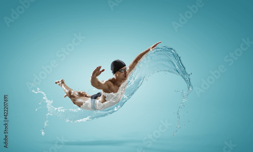 Professional man swimmer on a wave