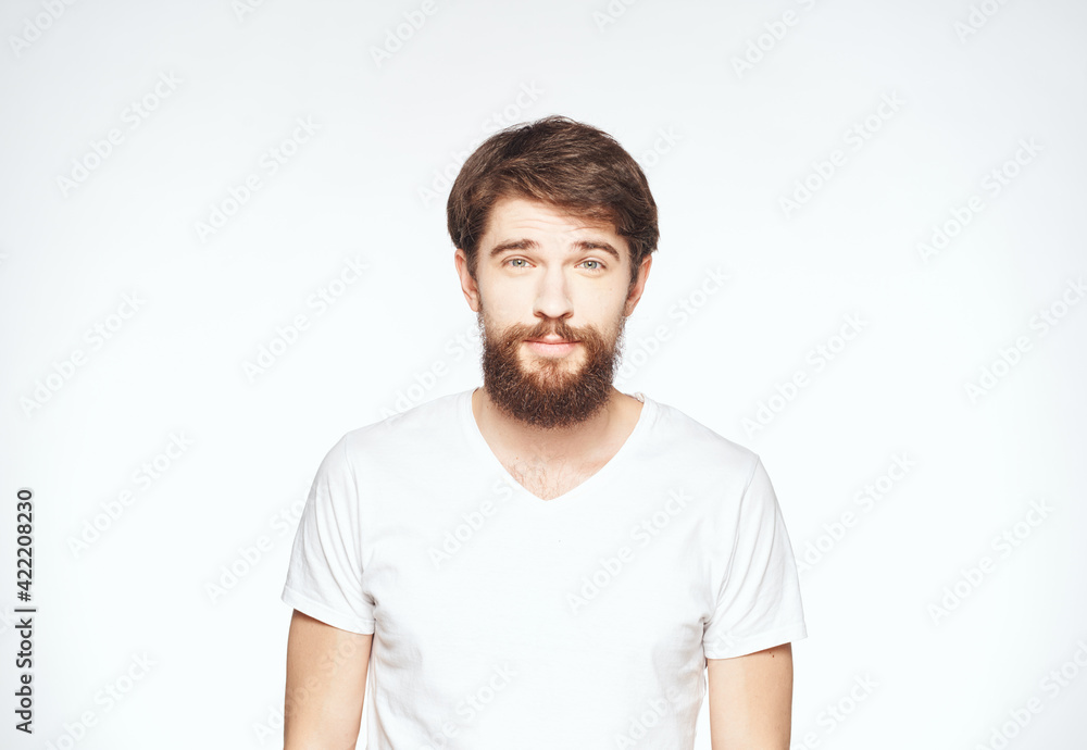 a man with a beard gestures with his hands on a light background Copy Space man a man with a beard gestures with his hands on a light background Copy Space man