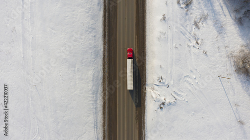 top view of a truck moving along the highway, transportation of goods in any weather conditions