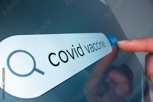 Close-up view of searching information on COVID 19 vaccine on the internet, shot with macro probe lens
