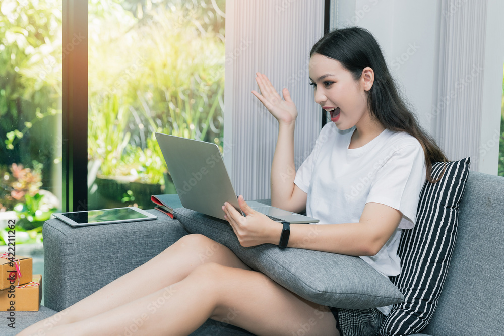 Successful entrepreneur business woman with online sales and Parcel shipping in her home office. Woman checking order on laptop. Successful entrepreneur business woman with online sales and Parcel shipping in her home office. Woman checking order on laptop.