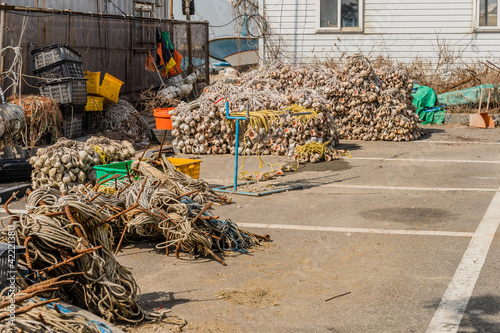 Nets, rope and other fishing gear stored in parking lot. photo