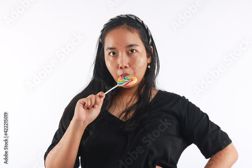 Fashion portrait young woman and lollipop is having fun over white background.