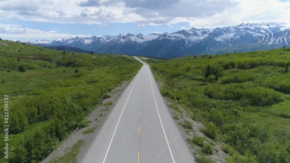 Aerial pull back from Alaskan road on mountain Aerial pull back from Alaskan road on mountain