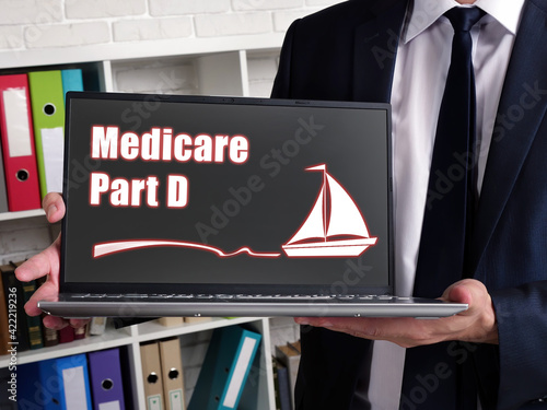 Business concept meaning Medicare Part D with sign on card in hand.