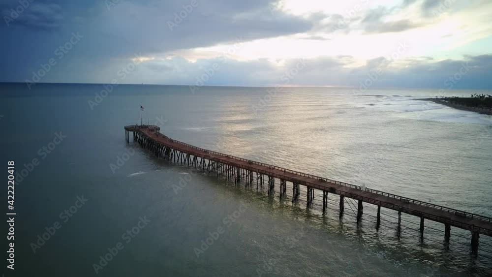 Aerial shot flying over the pier during the evening Aerial shot flying over the pier during the evening