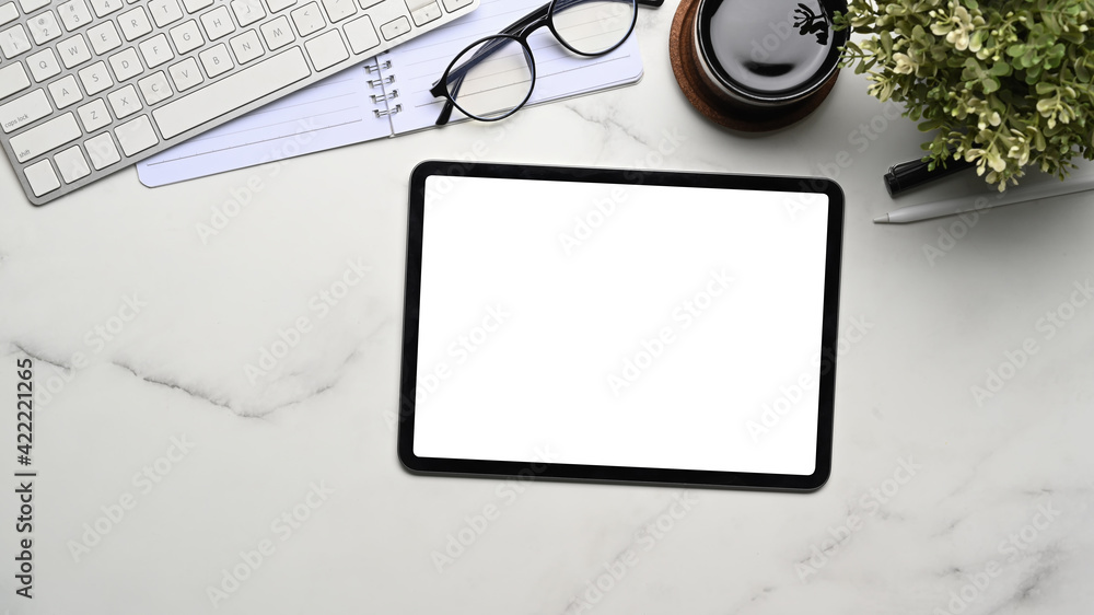 Top view of mock up digital tablet with empty screen, coffee cup, house plant and notebook on marble background. Top view of mock up digital tablet with empty screen, coffee cup, house plant and notebook on marble background.