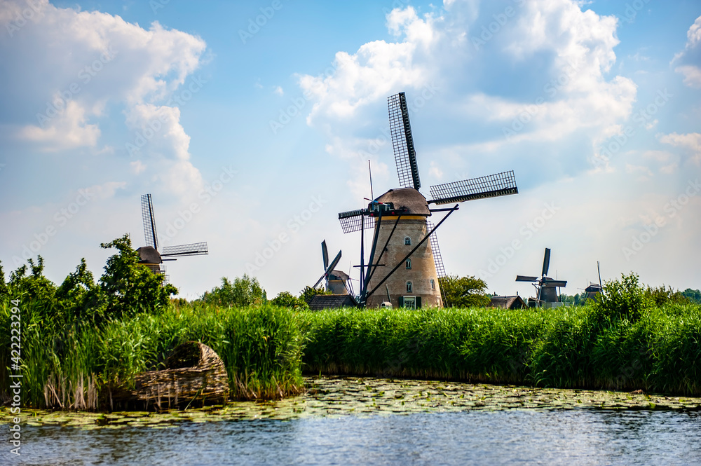 Scenic rural view with canals and traditional Dutch windmills at Kinderdijk, the Netherlands, on a summer day