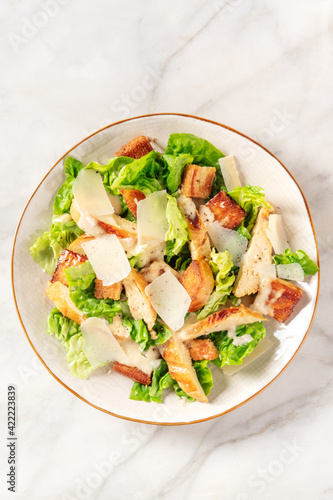 Caesar salad with grilled chicken, lettuce and Parmesan