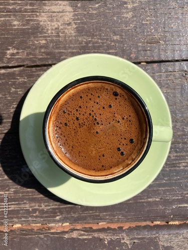 Top view of a cup of Turkish coffee. Green vintage cup. 
