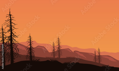 A dramatic silhouette of the mountains and dry trees at dusk. Vector illustration