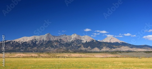 sand dunes and mountain peaks on a sunny day in great sand dunes national park,  near alamosa, colorado  photo