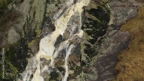 Glenmacnass Waterfall, Wicklow, Ireland, February 2020. Drone Birdseye view, follows the river while slowly descending from the top of the waterfall. photo