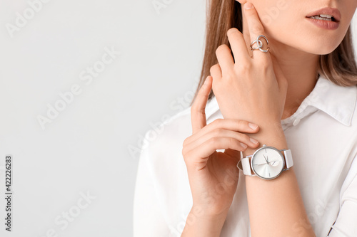 Fotografia Woman with stylish wrist watch on white background