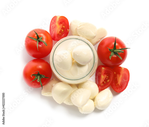 Glass jar with mozzarella cheese and tomatoes on white background