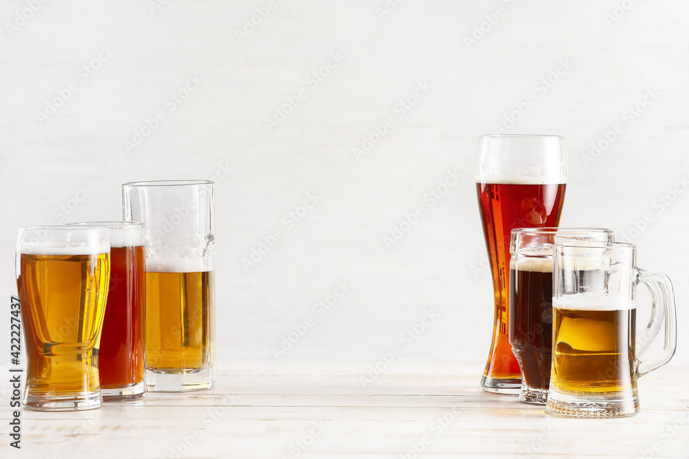 Glasses of different fresh beer on light background Glasses of different fresh beer on light background