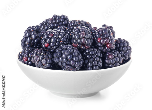 Bowl with fresh ripe blackberry on white background