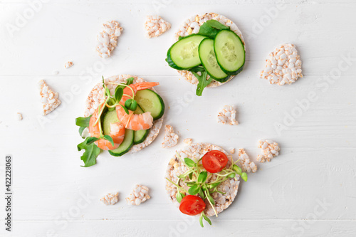 Composition with rice crackers on white wooden background
