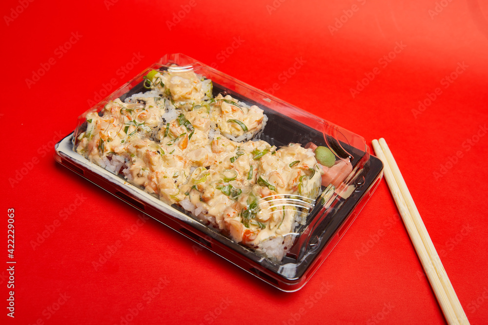 Take out Sushi Volcano Roll on a plastic container Take out Sushi Volcano Roll on a plastic container