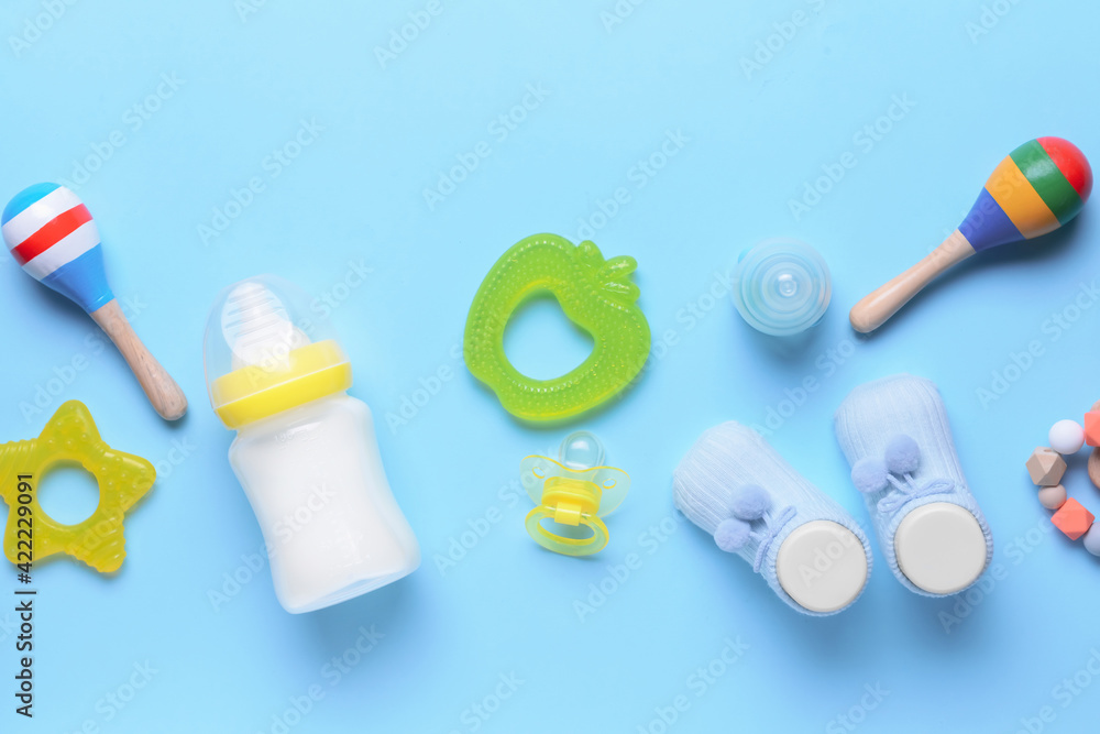 bottle-of-milk-for-baby-and-accessories-on-color-background-stock-photo