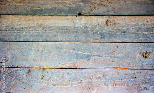 The wall of a village hut made of wooden boards. Natural material.