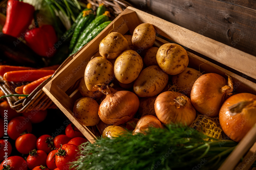 Fresh vegetables in a wooden box on a wooden background. Fruits and vegetables market Fresh vegetables in a wooden box on a wooden background. Fruits and vegetables market