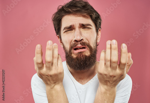 Upset man gesturing with hands stress emotions model pink background