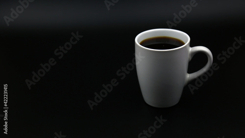 Close up black hot coffee white mug with black background.