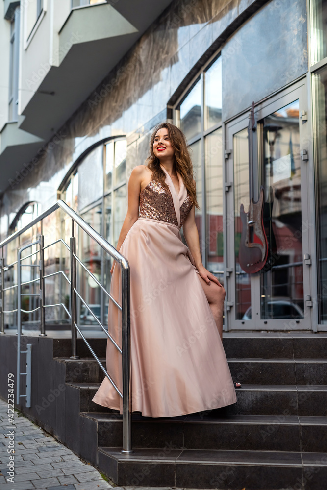 Hot summer beauty lady in fashion cocktail silk dress walk in city
