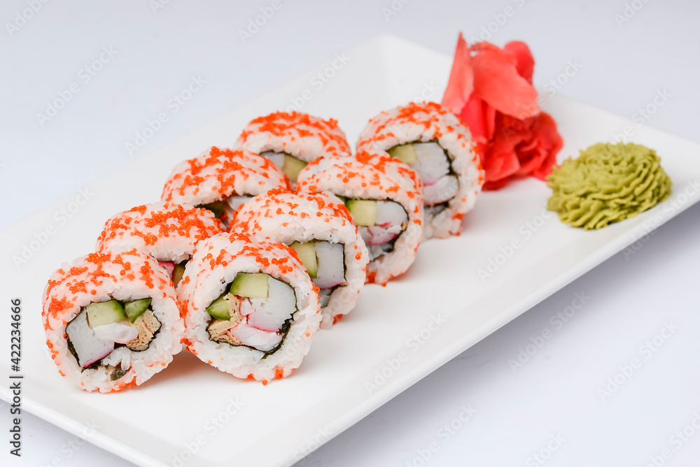 Sushi large set served on a white plate over white background. Traditional Asian Japanese cuisine concept. Sushi large set served on a white plate over white background. Traditional Asian Japanese cuisine concept.