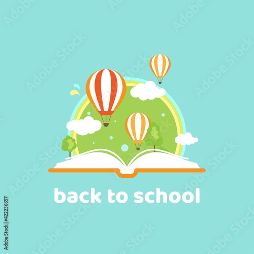 Open book with air balloon, rainbow and clouds isolated on powder blue background.