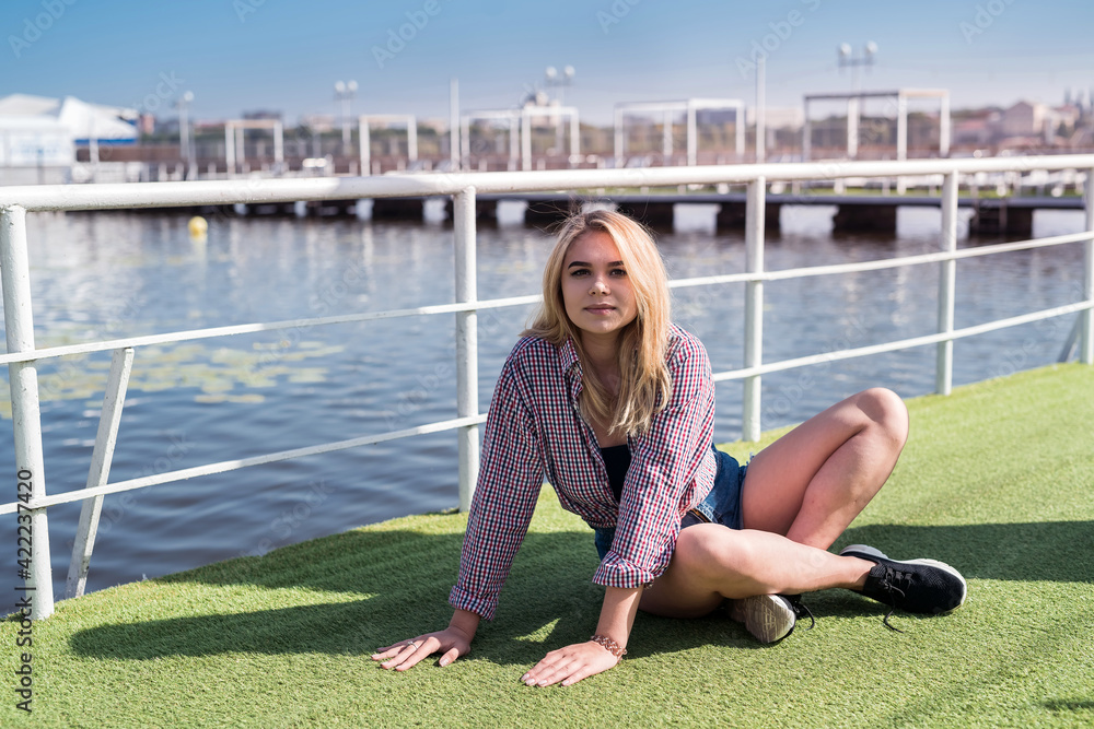 Fototapeta premium portrait of pretty teenage girl in near a city pond, summer time